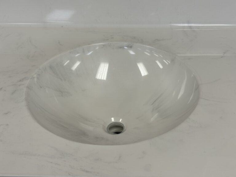 round cast marble sink integrated into cast marble countertop